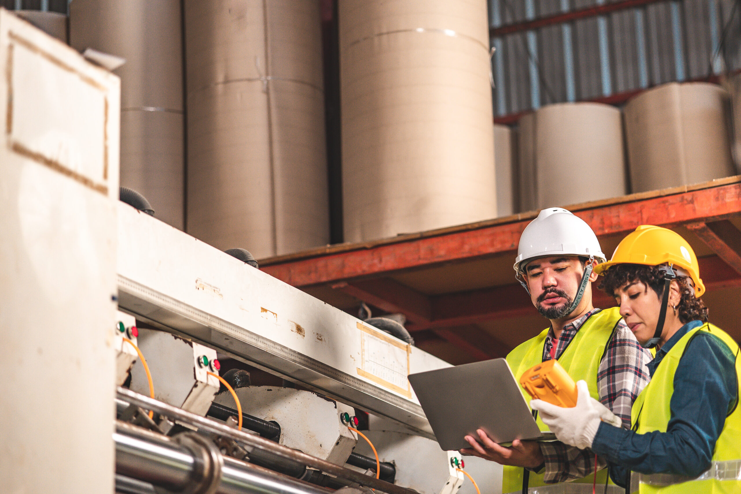 Workers inspecting corrugated board production